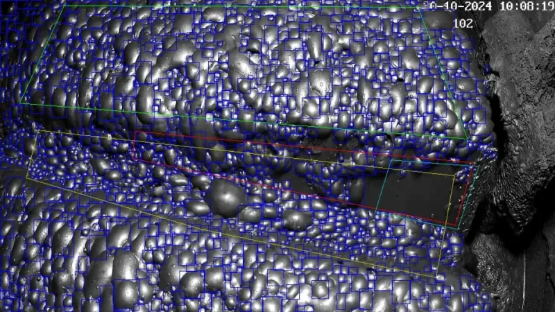 Computer vision system analyzing flotation froth, showing bubble detection overlay on a live flotation cell camera feed